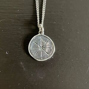 Waxing Poetic compass necklace.